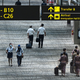 Singapore Airlines flight crew members walk along the transit hall of the Changi International Airport in Singapore on September 3, 2021.